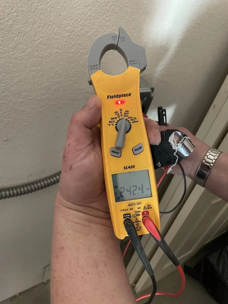 Voltage testing with clamp meter during Outlet Installation in Elroy